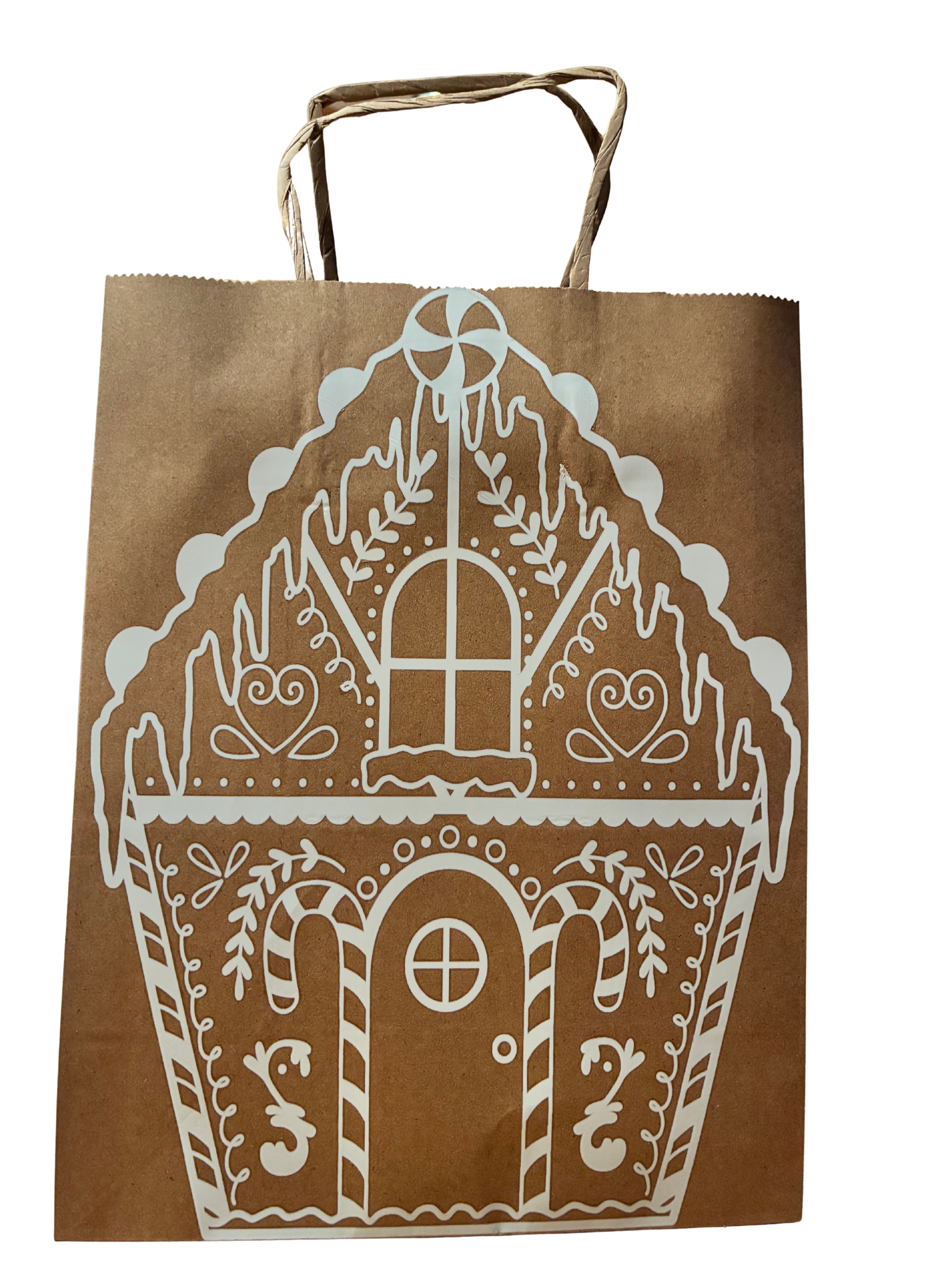 Brown paper bag with white gingerbread house design on a white background